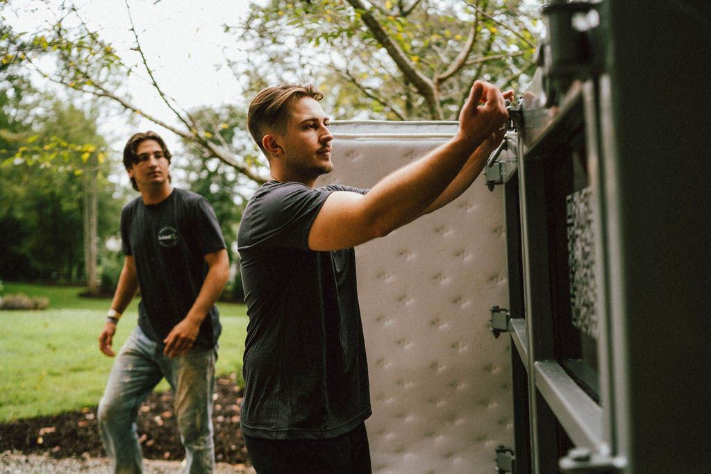 A Loader latching the trailer gate with the mattress loaded