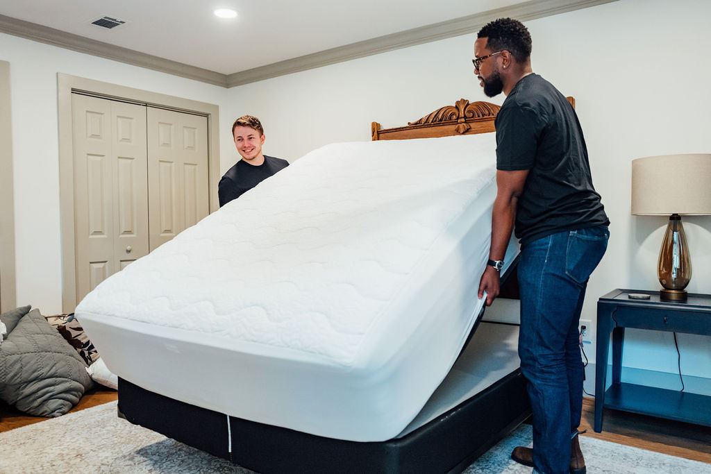 Two Loaders lifting a queen mattress off the bed frame during an in home removal