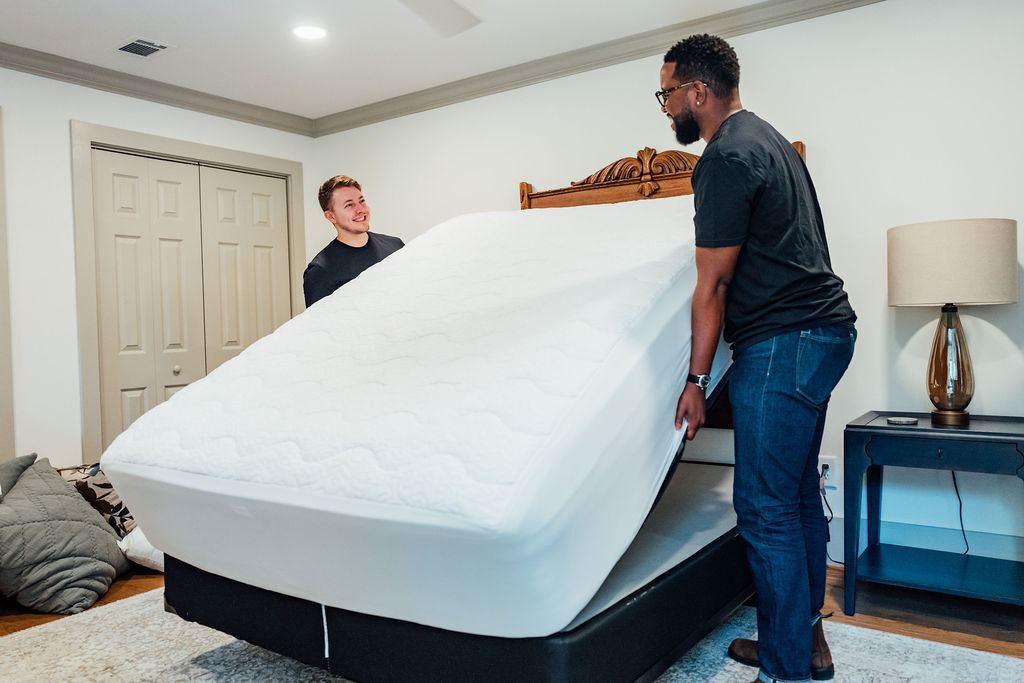 Loaders tilting a mattress off the box spring in a customer bedroom
