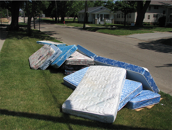 A bunch of mattress piled on the curb show the need for Mattress Disposal and Recycling in Orlando, Florida